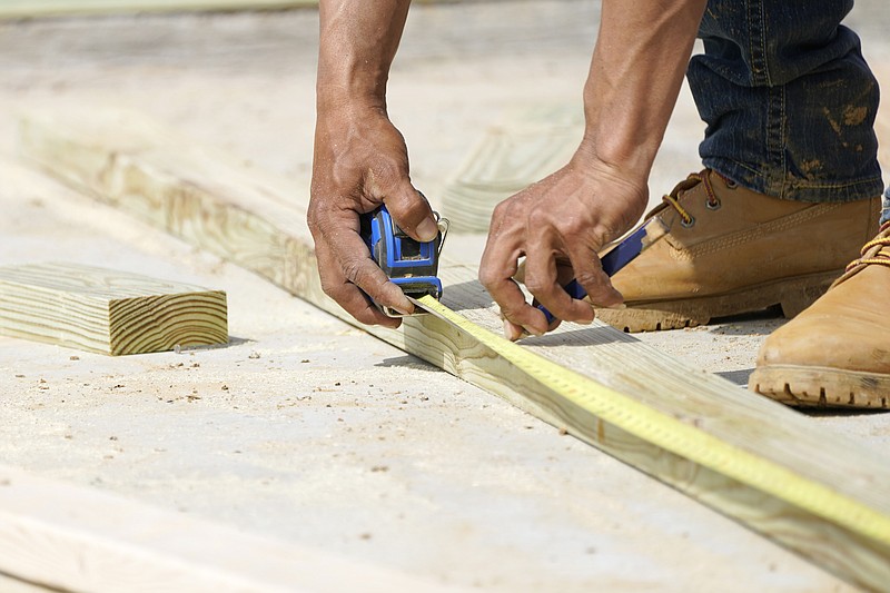 A beam is measured and marked at a housing site in Madison County, Miss., Tuesday, March 16, 2021. After a year of spending more time at home due to the COVID-19 pandemic, homeowners are looking to adapt their spaces to their new realities. In 2021, expect to see more interest in creating dedicated spaces within the home. (AP Photo/Rogelio V. Solis)