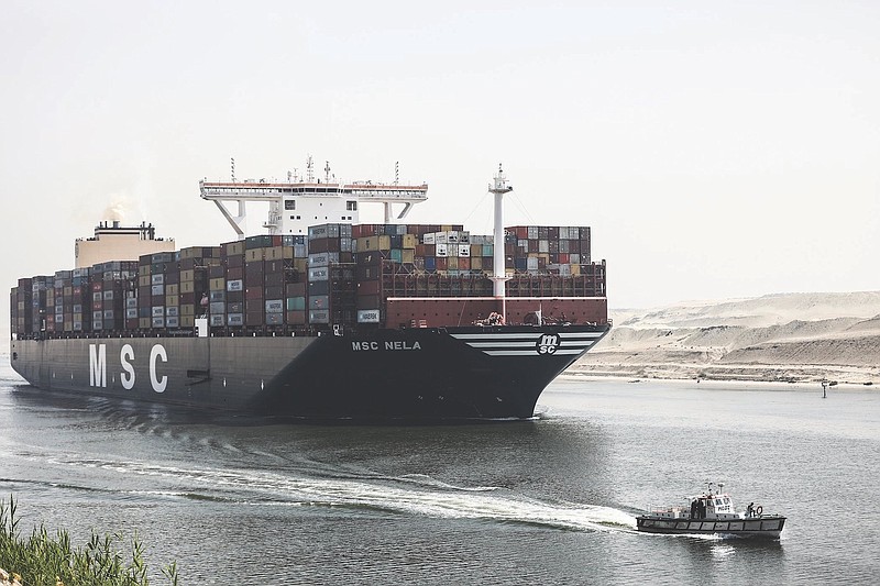 AP Photo/Mohamed Elshahed / A container ship passes through Suez Canal, Egypt. The Suez Canal chief said that authorities are negotiating a financial settlement with the owners of a massive vessel that blocked the crucial waterway for nearly a week in March.