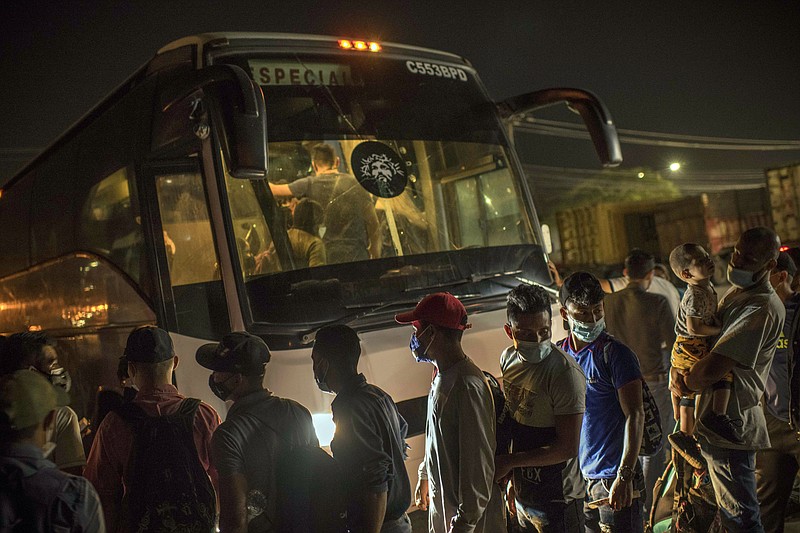 New York Times photo by Daniele Volpe / People board a bus on March 26 in San Pedro Sula, Honduras, bound for Guatemala. For some, this is the first step in a journey of migration toward the United States.