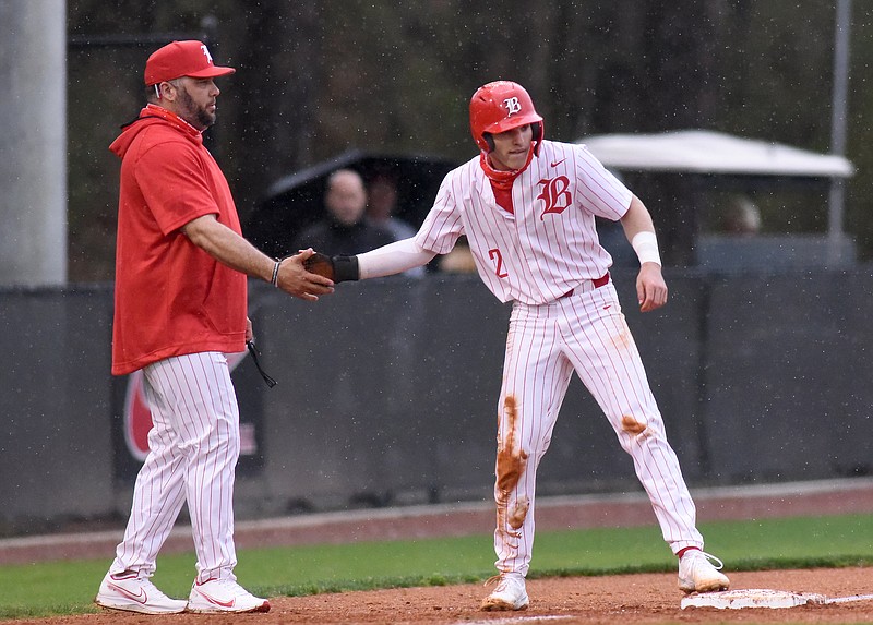 Staff photo by Matt Hamilton / Baylor baseball coach Greg Elie congratulates Henry Godbout after he made it to third during a home game on March 15. Godbout had two hits Saturday as the Red Raiders won 8-2 against Silverdale Baptist Academy to improve to 10-2. The Seahawks fell to 12-2-1.