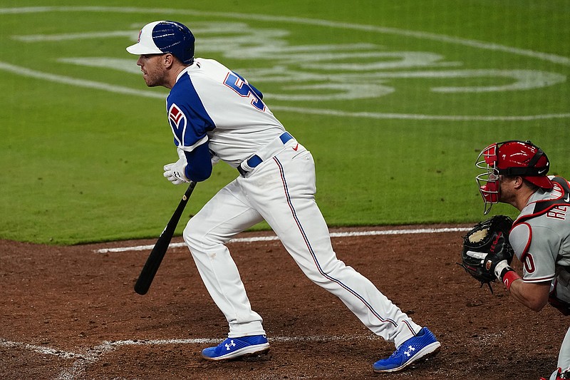 AP photo by John Bazemore / Atlanta Braves first baseman Freddie Freeman drives in a run with a ground ball as Philadelphia Phillies catcher J.T. Realmuto looks on in the seventh inning of Saturday night's game in Atlanta.