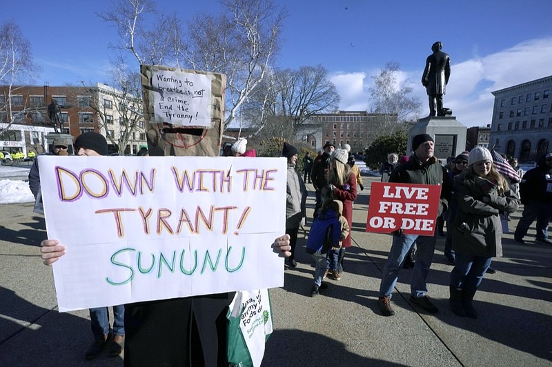 FILE - In this Thursday, Jan. 7, 2021 file photo, people protest outside the Statehouse in Concord, N.H., as Gov. Chris Sununu is inaugurated at noon for his third term as governor. (AP Photo/Charles Krupa)


