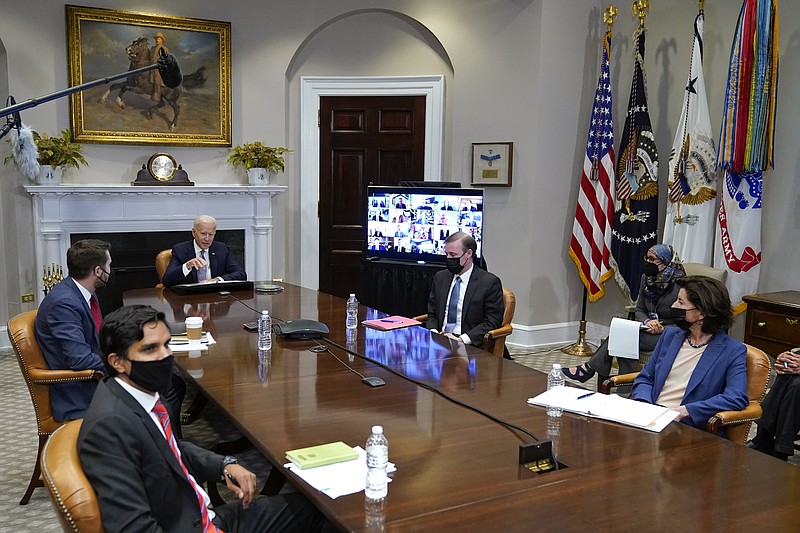President Joe Biden participates virtually in the CEO Summit on Semiconductor and Supply Chain Resilience in the Roosevelt Room of the White House, Monday, April 12, 2021, in Washington. Seated with Biden are Daleep Singh, Deputy National Security Adviser and Deputy Director of the National Economic Council, clockwise from bottom left, National Economic Council Director Brian Deese, National Security Adviser Jake Sullivan and Commerce Secretary Gina Raimondo. (AP Photo/Patrick Semansky)