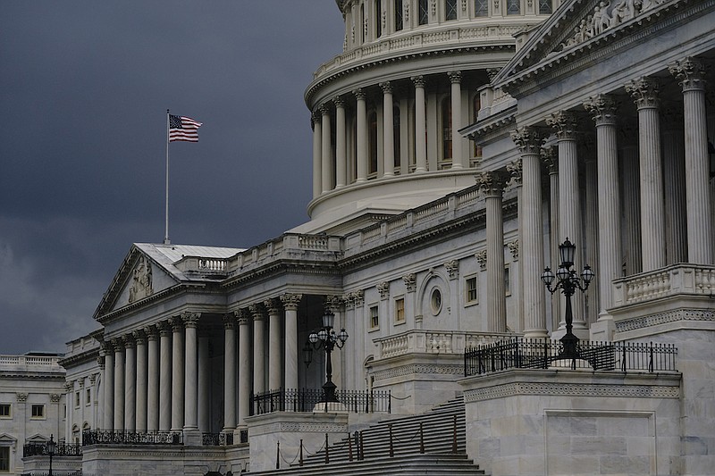 In this Aug. 3, 2020, file photo dark clouds and heavy rain sweep over the U.S. Capitol in Washington. The U.S. government's budget deficit surged to an all-time high of $1.7 trillion for the first six months of this budget year, nearly double the previous record, as another round of economic-support checks added billions of dollars to spending last month. (AP Photo/J. Scott Applewhite, File)