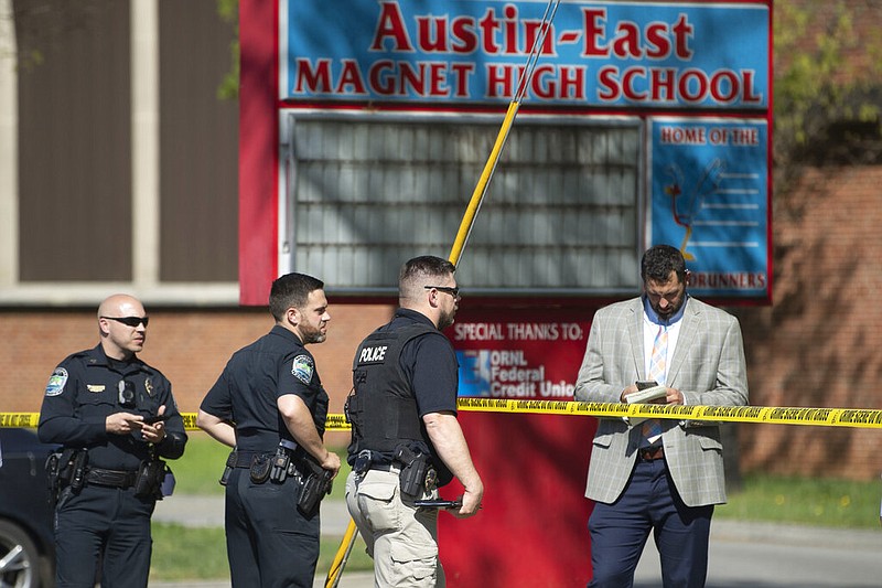 Law enforcement officers respond to a shooting at Austin-East Magnet High School in Knoxville, Tenn., Monday, April 12, 2021. Authorities say multiple people including a police officer have been shot at the school. (Saul Young/The News Sentinel via AP)