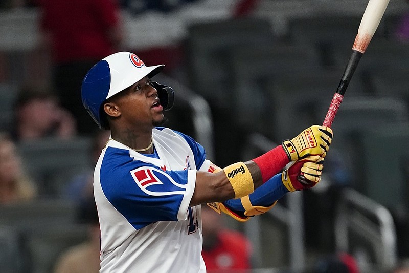 Atlanta Braves right fielder Ronald Acuna Jr. (13) follows through on a two-run home run in the fifth inning of a baseball game against the Philadelphia Phillies, Friday, April 9, 2021, in Atlanta. (AP Photo/John Bazemore)