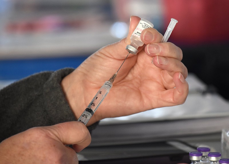 Staff Photo by Matt Hamilton / Nursing supervisor Nadine Stone fills syringes with vaccine at the vaccination site at First Baptist Cleveland in Cleveland, Tenn. on Tuesday, March 30, 2021.