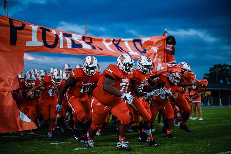 Photo by Cade Deakin / East Ridge football players take the field for a home game against Signal Mountain in September 2019.