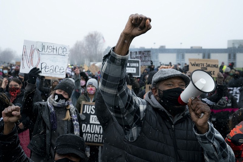 Demonstrators march to the Brooklyn Center Police Department to protest the fatal shooting of Daunte Wright during a traffic stop, Tuesday, April 13, 2021, in Brooklyn Center, Minn. (AP Photo/John Minchillo)