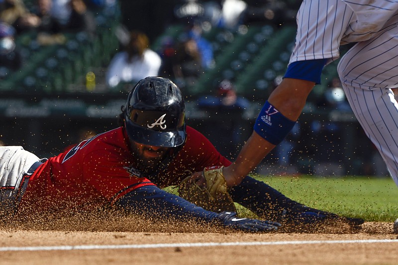 AP photo by Matt Marton / Atlanta Braves baserunner Dansby Swanson is tagged at third by the Chicago Cubs' Kris Bryant during the fifth inning Friday afternoon at Wrigley Field. The Braves started a five-game road trip by holding on for a 5-2 victory.