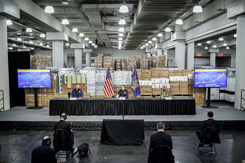 FILE — In this March 24, 2020 file photo, New York Gov. Andrew Cuomo, center, speaks while practicing social distancing, during a news conference at the Jacob Javits Center, in New York. (AP Photo/John Minchillo, File)



