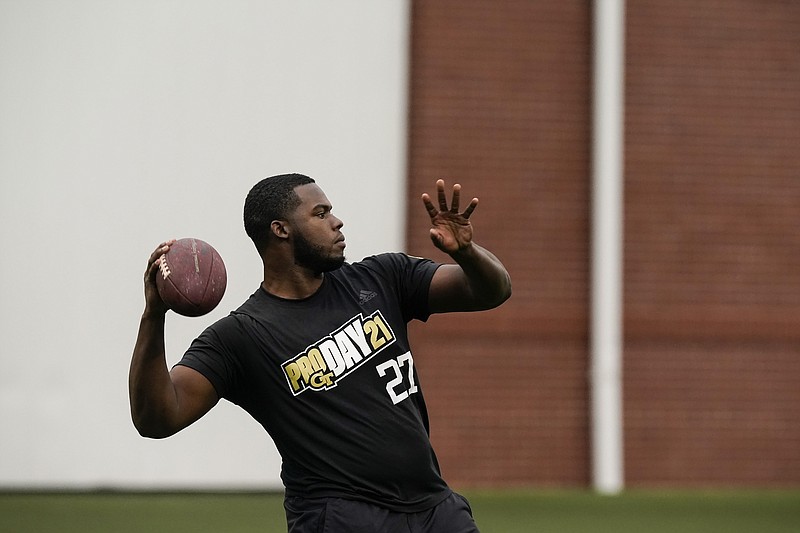 AP photo by Brynn Anderson / Georgia Tech punter Pressley Harvin III throws a pass in front of NFL scouts during the Yellow Jackets' pro day on March 16 in Atlanta. The 6-foot-4, 263-pound Harvin is known for not only a powerful leg but an arm that keeps the other team honest when he lines up to punt.