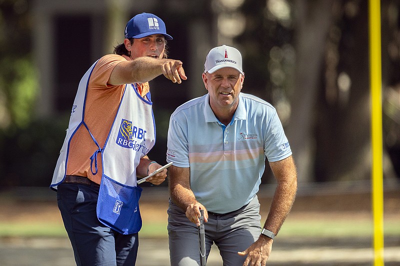 AP photo by Stephen B. Morton / PGA Tour golfer Stewart Cink, right, and his caddie and son Reagan Cink plan his shot on the seventh green at Harbour Town Golf Links during Sunday's final round of the RBC Heritage on Hilton Head Island in South Carolina. Cink closed with a 70 and won by four strokes.