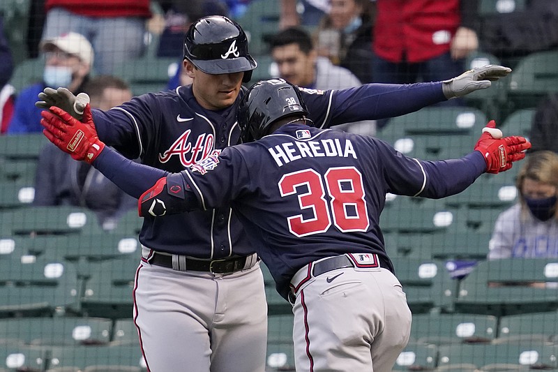 AP photo by Nam Y. Huh / The Atlanta Braves' Guillermo Heredia celebrates with Austin Riley after hitting a two-run homer during the first inning of Sunday night's game against the host Chicago Cubs.
