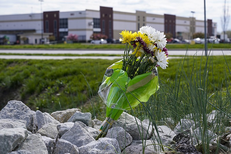 Photo by Michael Conroy of The Associated Press / A single bouquet of flower sits in the rocks across the street from the FedEx facility in Indianapolis on Saturday, April 17, 2021 where eight people were shot and killed. A gunman killed eight people and wounded several others before apparently taking his own life in a late-night attack at a FedEx facility near the Indianapolis airport, police said, in the latest in a spate of mass shootings in the United States after a relative lull during the pandemic.