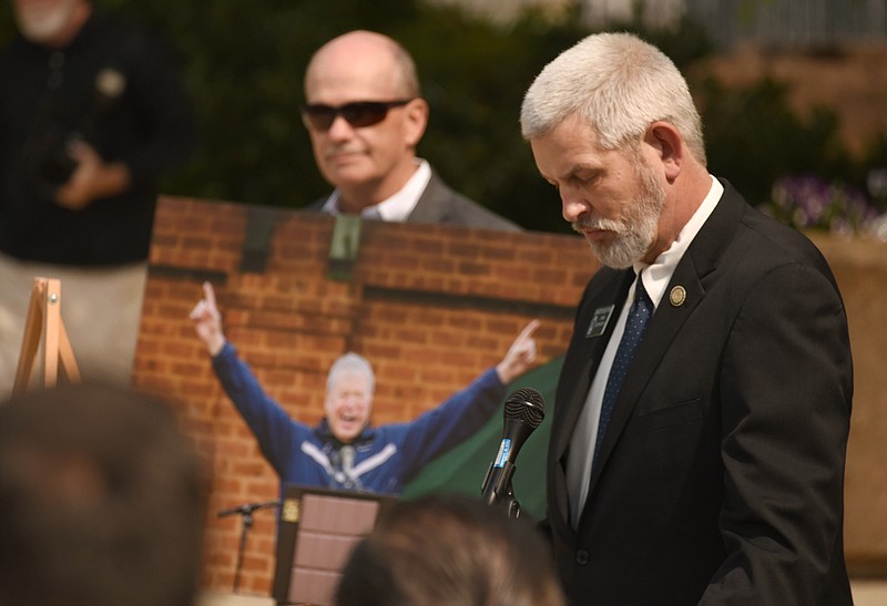 Staff Photo by Matt Hamilton / Georgia State Senator Chuck Payne, right, speaks during the Tony Ingle memorial  as city administrator Jason Parker holds a photo of the Dalton State coach at the Dalton Convention Center in Dalton, Ga. on Monday, April 19, 2021. 