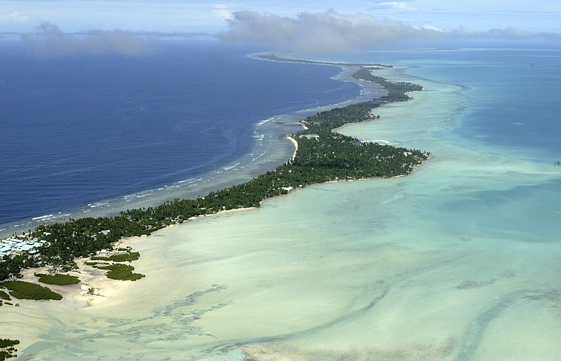 FILE - This March 30, 2004, file photo, shows Tarawa atoll, Kiribati. Ioane Teitiota and his wife fought for years to be allowed to stay in New Zealand as refugees, arguing that rising sea levels caused by global warming threaten the very existence of their tiny Pacific nation of Kiribati, one of the lowest lying countries on Earth. (AP Photo/Richard Vogel, File)

