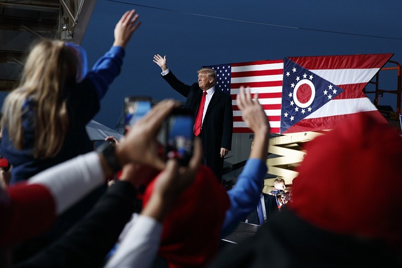FILE- In this Oct. 12, 2018 file photo then President Donald Trump waves as he arrives for a campaign rally, in Lebanon, Ohio. A GOP-backed bill introduced Monday, April 20, 2021, would change the name of a state park to honor Trump. The House bill primarily sponsored by freshmen Rep. Mike Loychik to rename Mosquito State Park to Donald J. Trump State Park is the latest attempt by Ohio Republicans to honor the former president. (AP Photo/Evan Vucci, File)
