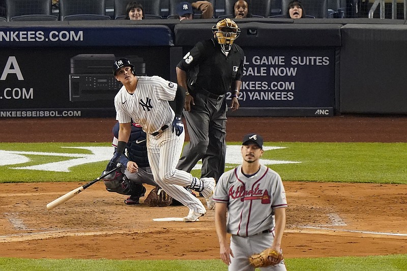 New York Yankees Gio Urshela watches his solo home run as Atlanta Braves starting pitcher Charlie Morton reacts during the fifth inning of an interleague baseball game, Tuesday, April 20, 2021, at Yankee Stadium in New York. Home plate umpire Laz Diaz keeps his eye on the ball. (AP Photo/Kathy Willens)