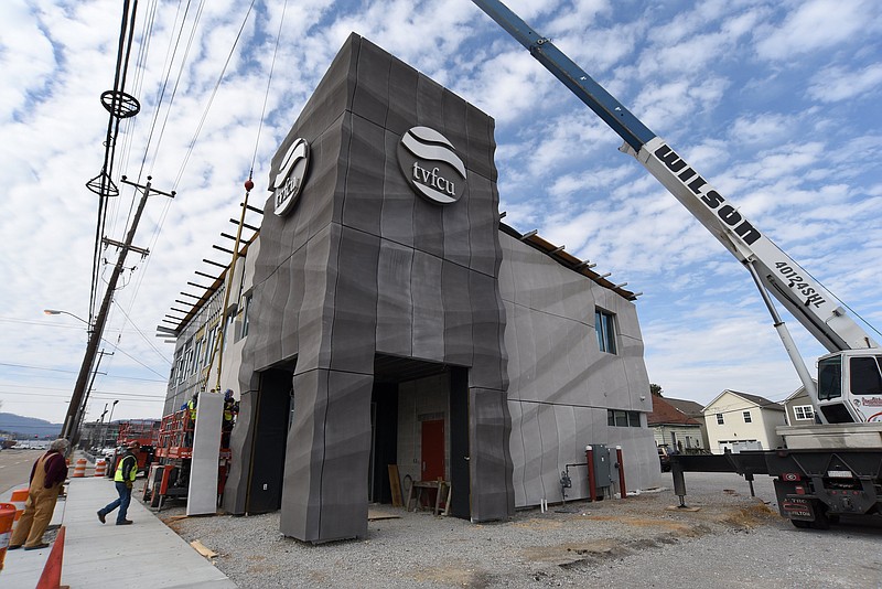 Staff Photo by Matt Hamilton / A construction crew adds another panel to the facade at the new branch location for Tennessee Valley Federal Credit Union on Wednesday, Feb. 17, 2021. 
