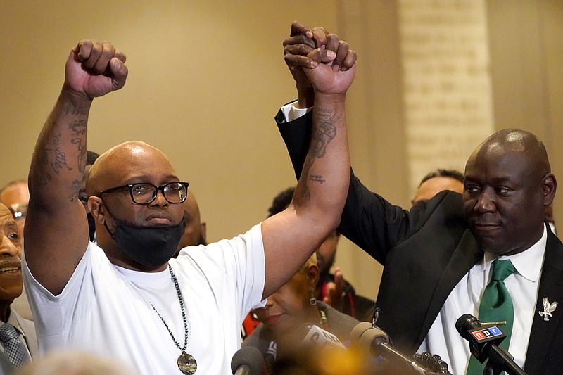 Photo by Julio Cortez of The Associated Press / Terrence Floyd, brother of George Floyd, holds his hands up with the help of Ben Crump, attorney representing George Floyd's family, during a news conference after the verdict was read in the trial of former Minneapolis Police Officer Derek Chauvin on Tuesday, April 20, 2021, in Minneapolis.