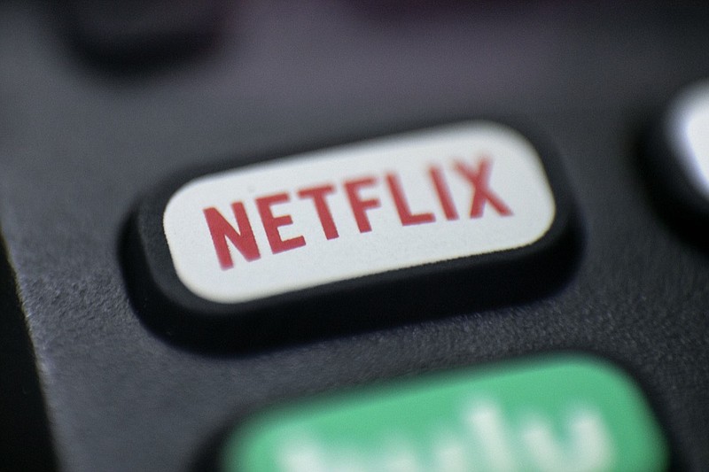 FILE - This Aug. 13, 2020 photo shows a logo for Netflix on a remote control in Portland, Ore. Netflix's rapid subscriber growth is slowing far faster than anticipated, Tuesday, April 20, 2021, as people who have been cooped at home during the pandemic are able to get out and do other things again. The video streaming service added 4 million more worldwide subscribers from January through March, its smallest gain during that three-month period in four years. (AP Photo/Jenny Kane, File)