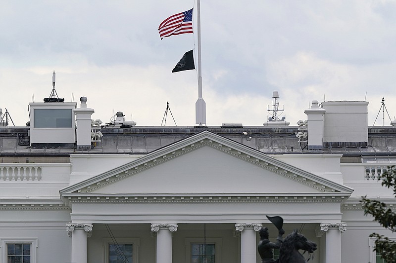 The American flag flies at half-staff over the White House in Washington, Friday, April 16, 2021. (AP Photo/Susan Walsh)