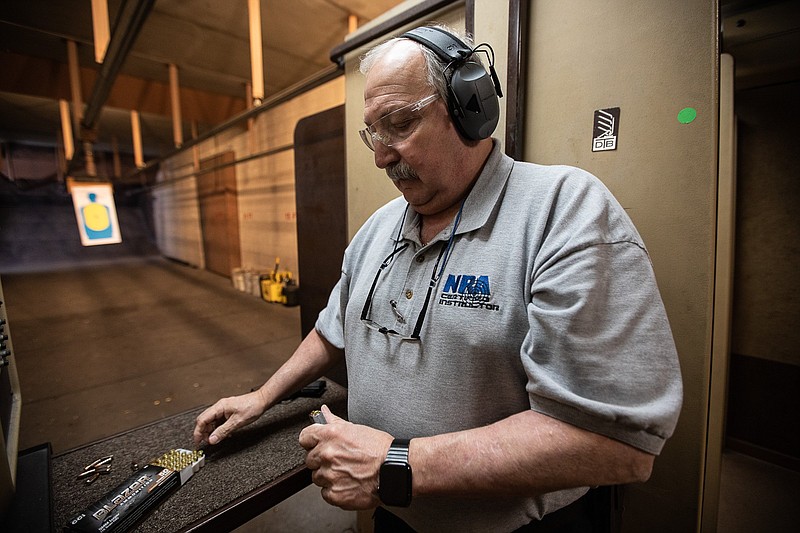 Staff photo by Troy Stolt / NRA-certified gun safety instructor Bob Drews loads ammunition into his personal firearm in the Shooter's Supply indoor range for a demonstration for the Times Free Press on Thursday, April 22, 2021, in Hixson, Tenn. Drews said he supports Tennessee's new permitless carry law, but he hopes that Chattanooga area residents understand that the additional rights to carry firearms do not extend to other states, and that Tennessee residents should take the time to educate themselves on proper firearm handling and legal use.