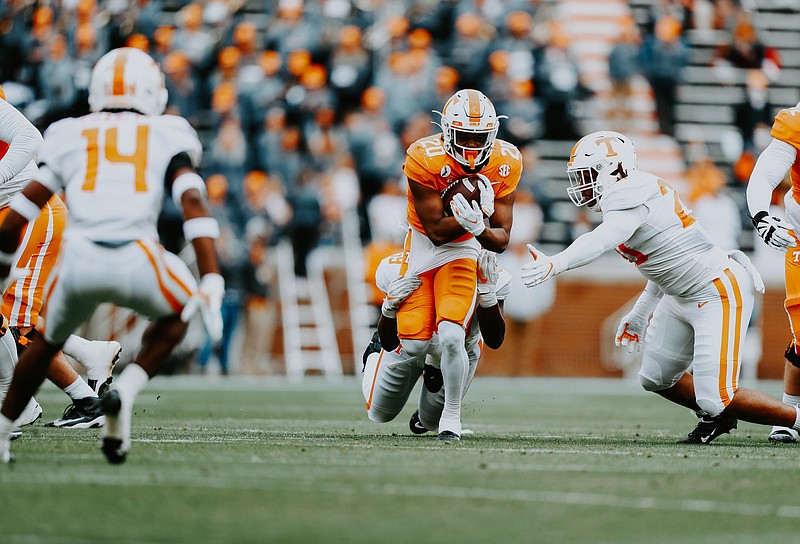 Tennessee Athletics photo / Tennessee sophomore running back Jabari Small fights for tough yards during the Orange & White game Staurday afternoon inside Neyland Stadium. Small rushed 12 times for 48 yards and scored two touchdowns.