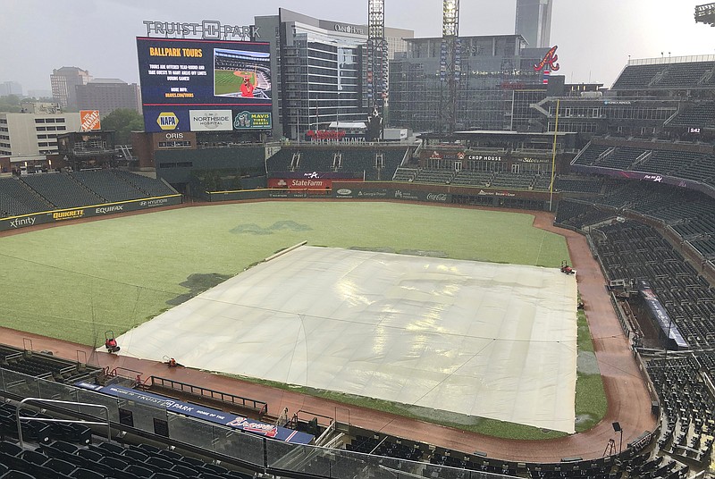 AP photo by Ben Margot / The outfield at Truist Park takes on a white cast during a hail storm prior to Saturday's scheduled game between the Atlanta Braves and the visiting Arizona Diamondbacks. The game was ultimately postponed and rescheduled for Sunday as part of a doubleheader with two seven-inning matchups.