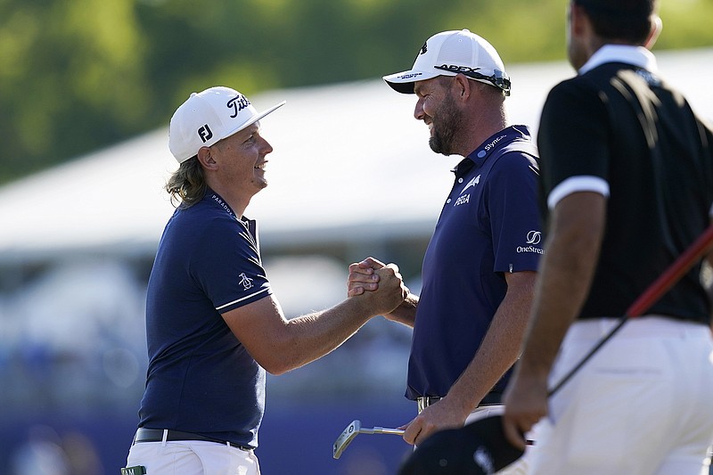 AP photo by Gerald Herbert / Cameron Smith, left, celebrates with his teammate and fellow Australian Marc Leishman after winning the PGA Tour's Zurich Classic of New Orleans on Sunday at TPC Louisiana.