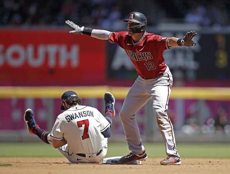 AP photo by Ben Margot / Arizona Diamondbacks baserunner Nick Ahmed signals he is safe after being tagged out on an attempted steal of second base by Atlanta Braves shortstop Dansby Swanson in the fourth inning of Sunday's first game in Atlanta. The Braves were swept in the doubleheader, losing 5-0 and 7-0 and totaling one hit.