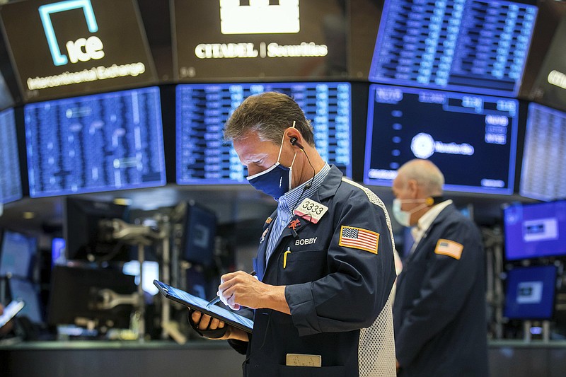 In this photo provided by the New York Stock Exchange, traders work on the floor, Monday, April 26, 2021. Stocks were higher in morning trading Monday as investors geared up for the busiest week for earnings so far this season. (Courtney Crow/New York Stock Exchange via AP)