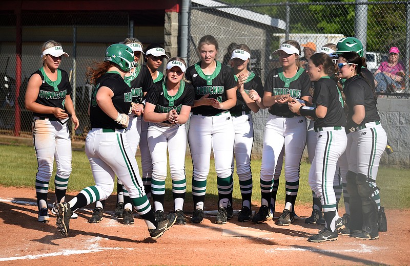 Staff Photo by Matt Hamilton / The Lady Canes greet East Hamilton (33) Ashlyn Watkins as she arrives home after hitting a solo home run at Ooltewah High School on Tuesday, April 27, 2021. 