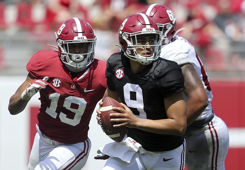 White team quarterback Bryce Young (9) rolls away from pressure during Alabama's April 17 spring game at Bryant-Denny Stadium.