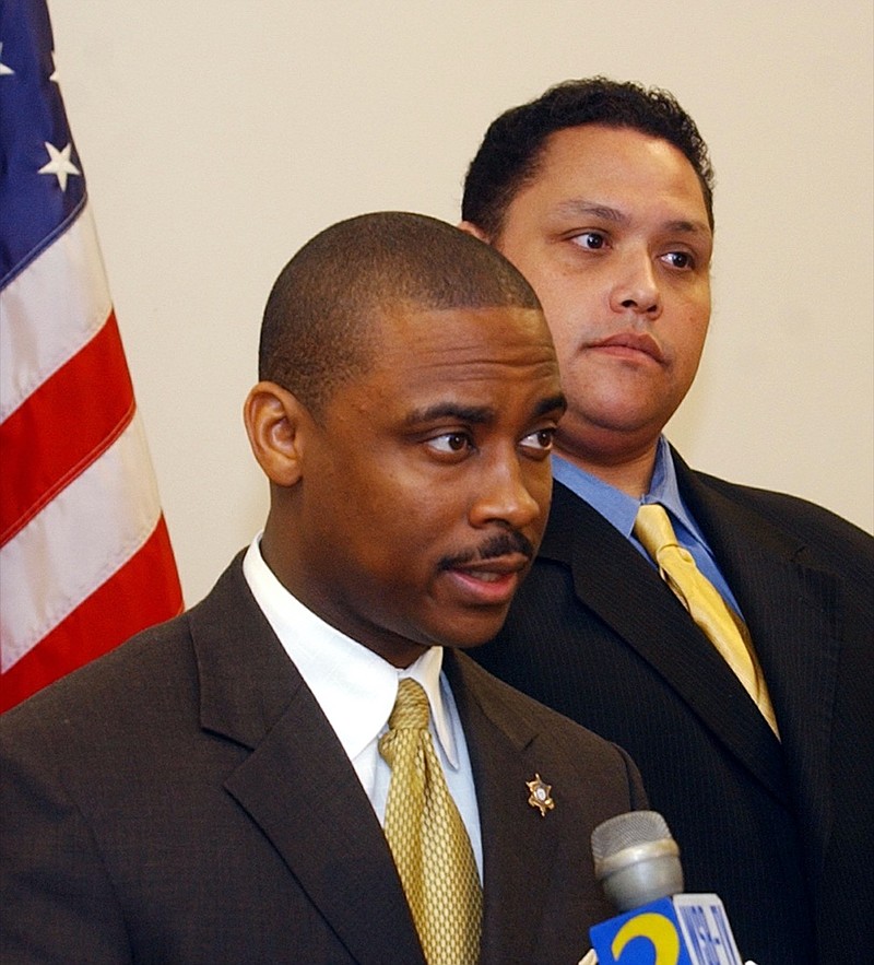 FILE - In this Jan. 11, 2005, file photo, Clayton County Sheriff Victor Hill, left, is flanked by a member of his legal team, attorney Rolf Jones, right, as he speaks during a news conference, in Jonesboro, Ga. The Atlanta-area sheriff, Hill, is accused of violating the civil rights of several people in his agency's custody by ordering that they be unnecessarily strapped into a restraint chair and left there for hours, according to a federal indictment. The indictment against Sheriff Hill was filed April 19, 2021, and was unsealed by a federal judge Monday, April 26. (AP Photo/Gene Blythe, File)