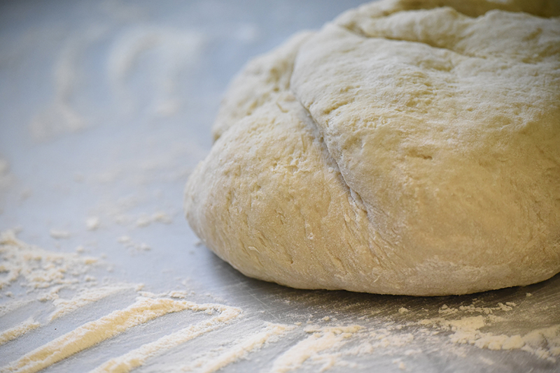 Staff photo by Matt Hamilton / Dough, which will become four loaves of bread, rests on a floured surface at Sunshine Hollow in Athens, Tenn.