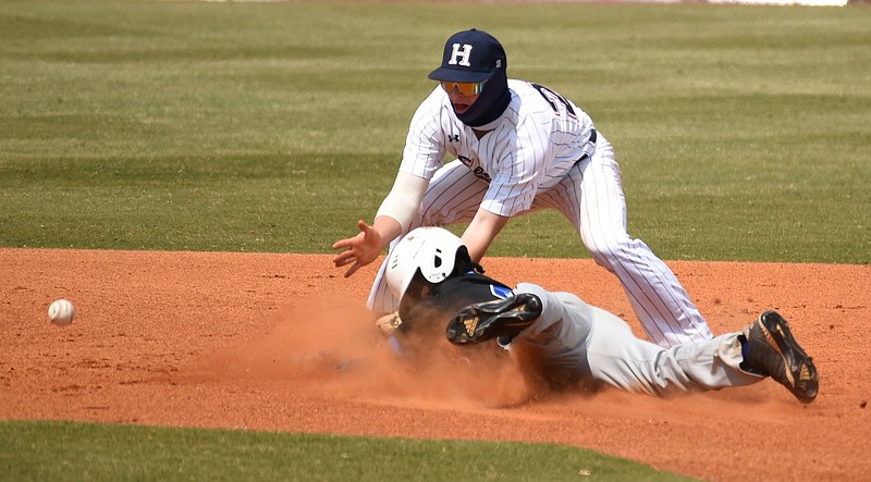 Staff photo by Matt Hamilton / Stephenson's Lonnie White slides in safely to second base as Heritage's Cannon Stafford can't handle the throw from home plate during Wednesday's GHSA Class AAAA baseball playoff matchup in Ringgold, Ga.