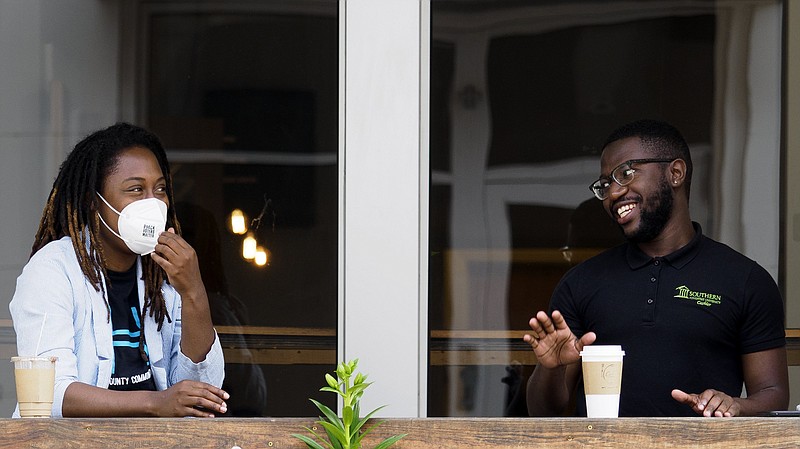 Staff photo by C.B. Schmelter / Ayana Clemmons, left, and Dylan Gibbons chat while having coffee at Cadence Coffee Company downtown on Thursday, April 29, 2021 in Chattanooga, Tenn. Hamilton County's mask mandate expired at midnight on April 28. The mandate has been described by Hamilton County Mayor Jim Coppinger as the most controversial policy decision of his career.