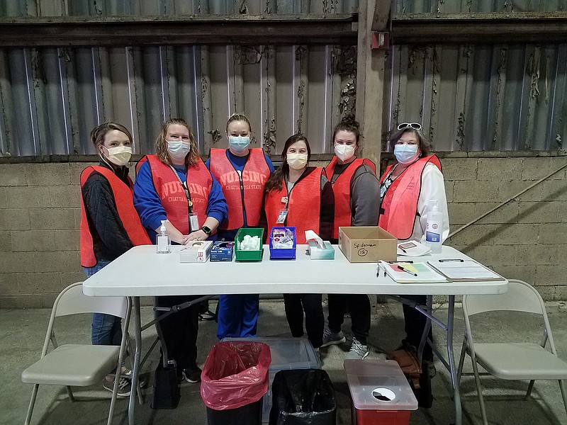 Chattanooga State night nursing students with their supervisor work the front lines preparing to administer COVID-19 vaccines at the CARTA bus barn. / Contributed photo