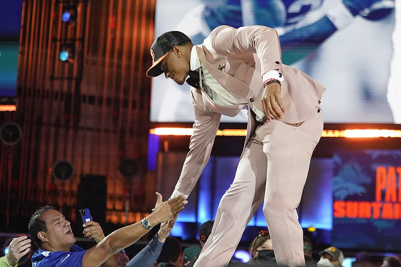 AP photo by Tony Dejak/ Former University of Alabama cornerback Patrick Surtain II greets fans in Cleveland on Thursday night after he was chosen by the Denver Broncos with the ninth pick of the NFL draft.