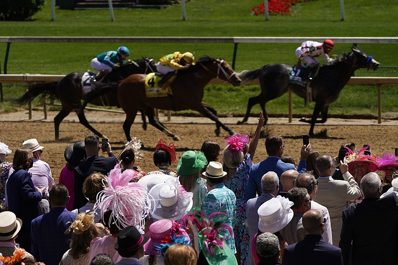 AP photo by Charlie Riedel / Fans watch a Kentucky Oaks undercard race Friday at Churchill Downs in Louisville, Ky. The 147th running of the Kentucky Derby is set for Saturday at the track.