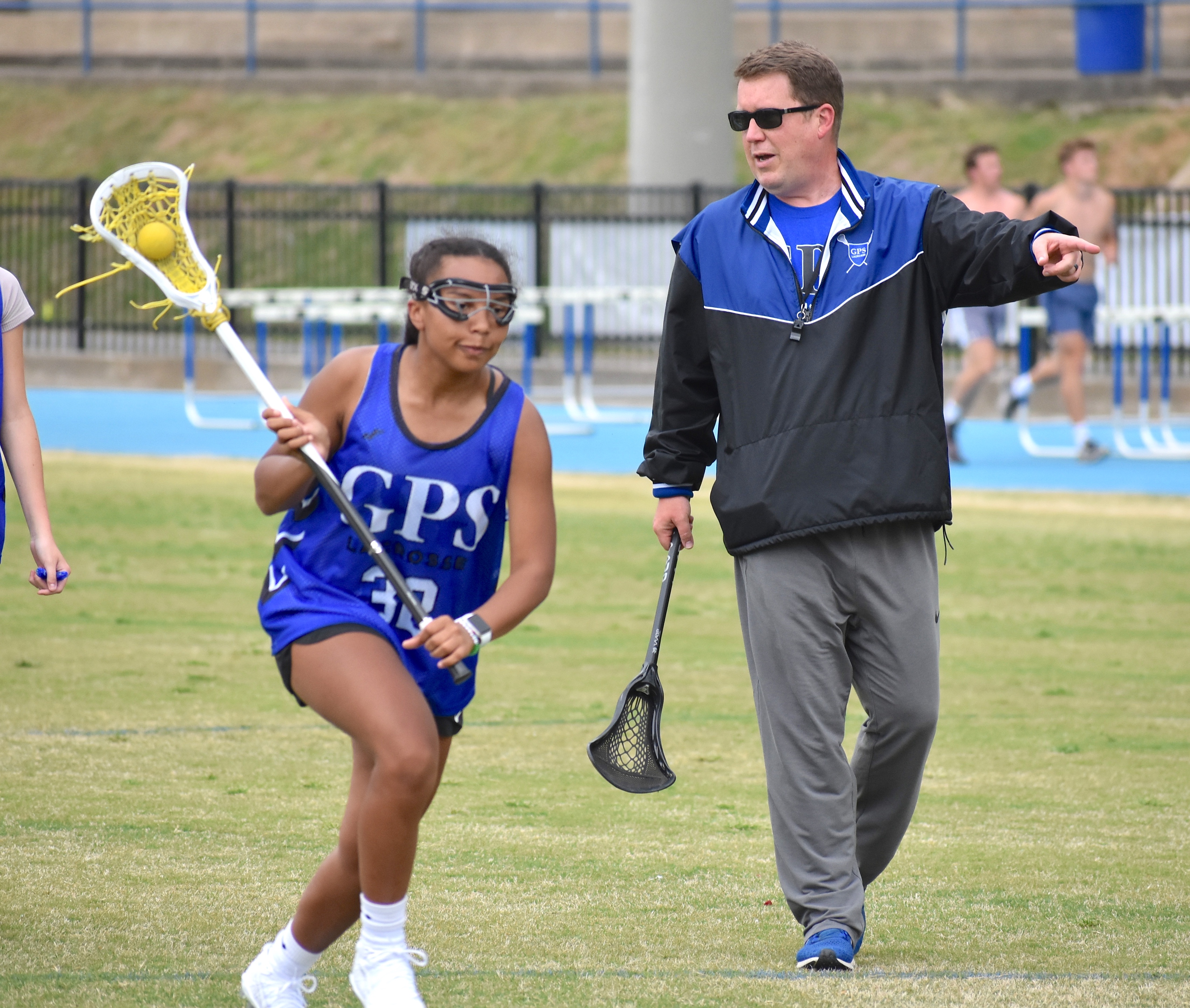 Staff photo by Patrick MacCoon / GPS lacrosse coach Jay Watts directs a drill during Thursday's practice.
