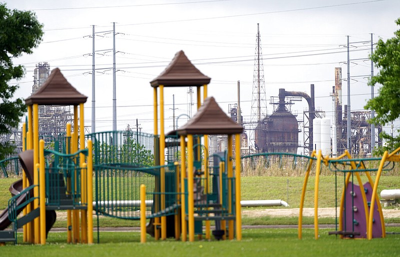 In this Monday, March 23, 2020 file photo, a playground outside the Prince Hall Village Apartments sits empty near one of the petrochemical facilities in Port Arthur, Texas. According to a study published Wednesday, April 28, 2021 in the journal Science Advances,  across America, people of color are disproportionately exposed to air pollution from industry, vehicles, construction and many other sources. (AP Photo/David J. Phillip)