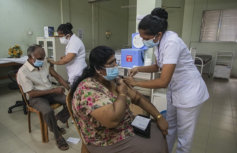 A Sri Lankan couple receive the vaccine for COVID-19 at a municipal health centre in Colombo, Sri Lanka, Friday, April 30, 2021. (AP Photo/Eranga Jayawardena)


