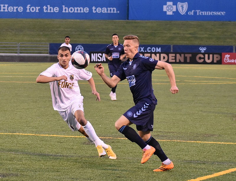 Staff photo by Patrick MacCoon / Chattanooga Football Club's Markus Naglestad, right, races for the ball during an NISA Legends Cup match against the Los Angeles Force on April 13 at Finley Stadium.