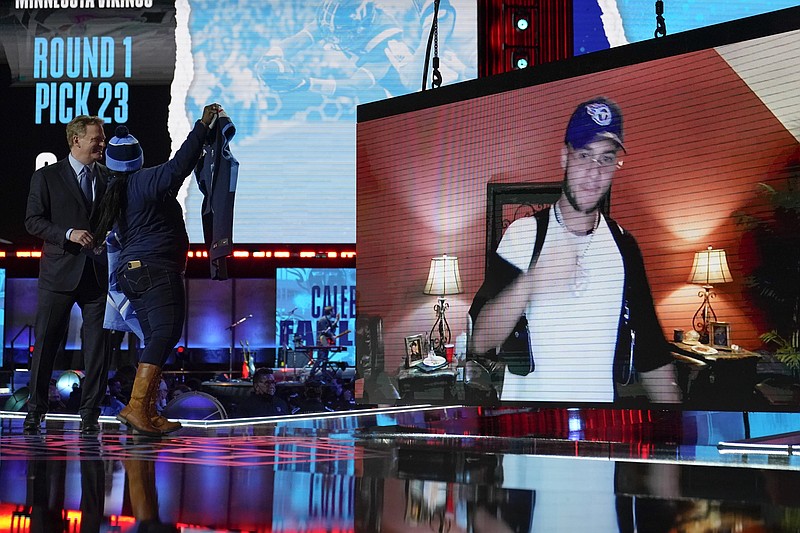 AP photo by Tony Dejak / An image of Virginia Tech cornerback Caleb Farley is displayed as a Tennessee Titans fan cheers on stage after Farley was chosen by the Titans with the 22nd pick in the first round of the NFL draft Thursday night in Cleveland.
