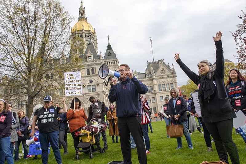 Joining thousands gathered outside the State Capitol, opponents of a bill to repeal Connecticut's religious exemption for school vaccinations pray outside the Capitol before the State Senate voted on the legislation, Tuesday, April 27, 2021, in Hartford, Conn. (Mark Mirko/Hartford Courant via AP)


