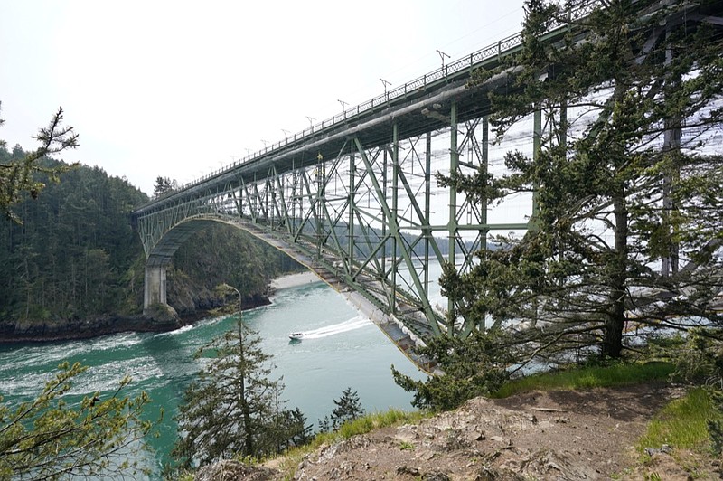 The Deception Pass Bridge, nearly 1,000-feet long and about 180-feet above the waters below, is covered in scaffolding as work to replace corroded steel and paint the structure continues Thursday, April 29, 2021, in Deception Pass, Wash. (AP Photo/Elaine Thompson)


