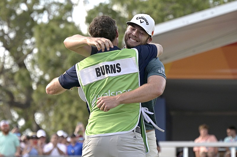 AP photo by Phelan M. Ebenhack / Sam Burns, right, is congratulated by his caddie after closing out his first PGA Tour victory at the Valspar Championship on Sunday in Palm Harbor, Fla.
